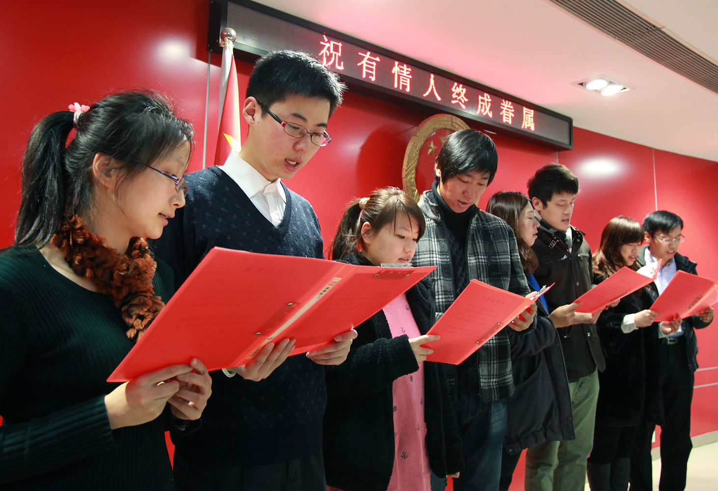 image: Couples read marriage vows in Shanghai.