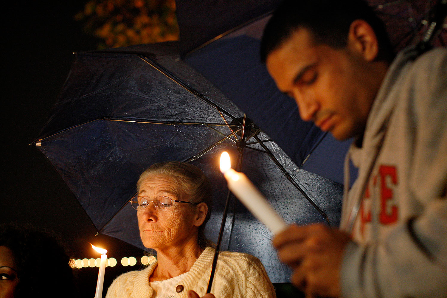 image: Doreen Finsinger and Raagir Quraishi pray during a candlelight vigil in memory of those killed in a mass shooting at Sandy Hook Elementary School in Connecticut, in Los Angeles, California