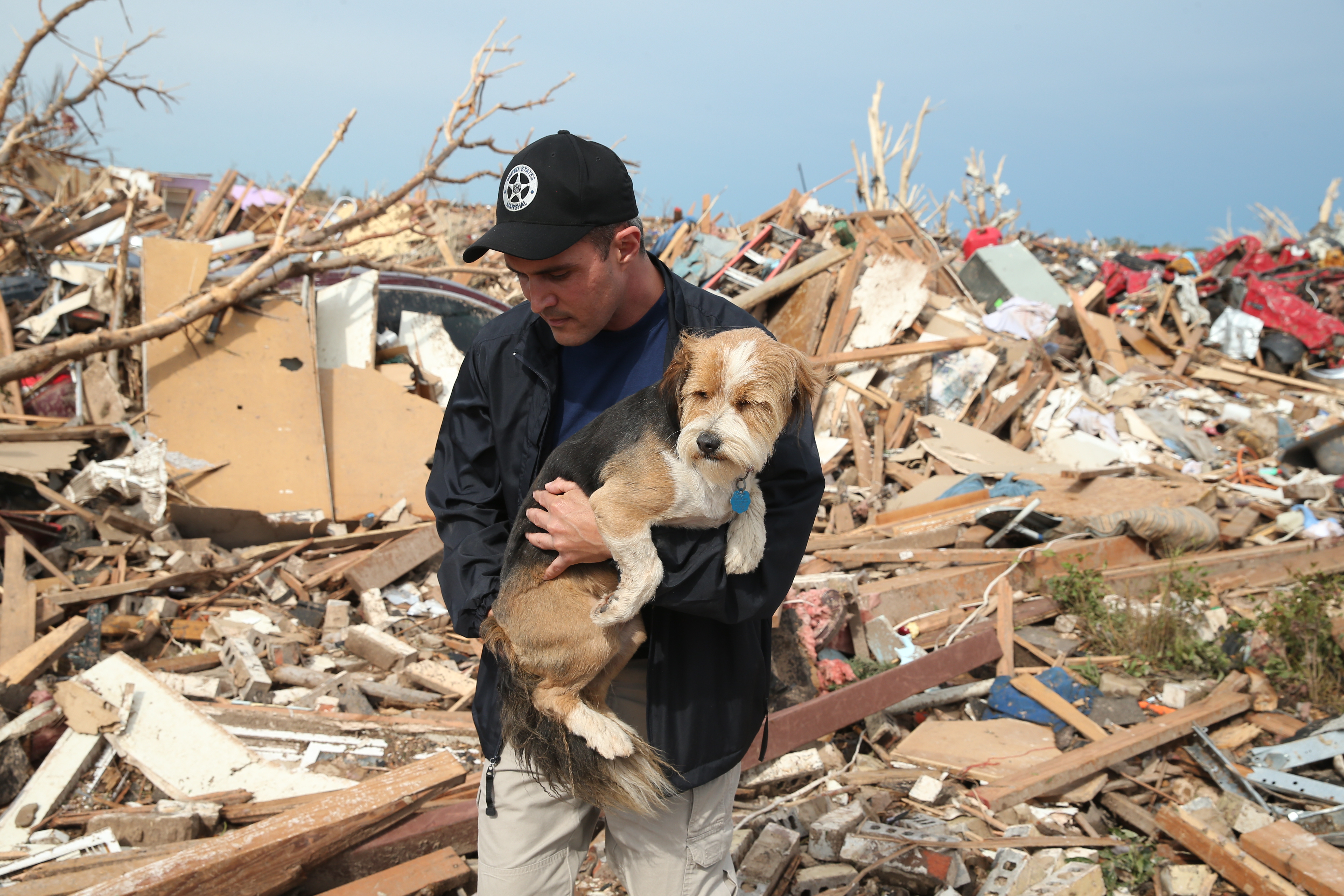 Sean Xuereb recovers a dog from the rubble of a home that was destroyed by a tornado on May 21, 2013 in Moore, Okla.