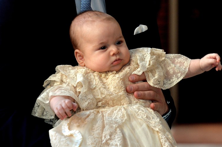 Britain's Prince William, Duke of Cambridge holds his son, Prince George of Cambridge, at Chapel Royal in St. James's Palace in central London for the christening of the baby on Oct. 23, 2013.
