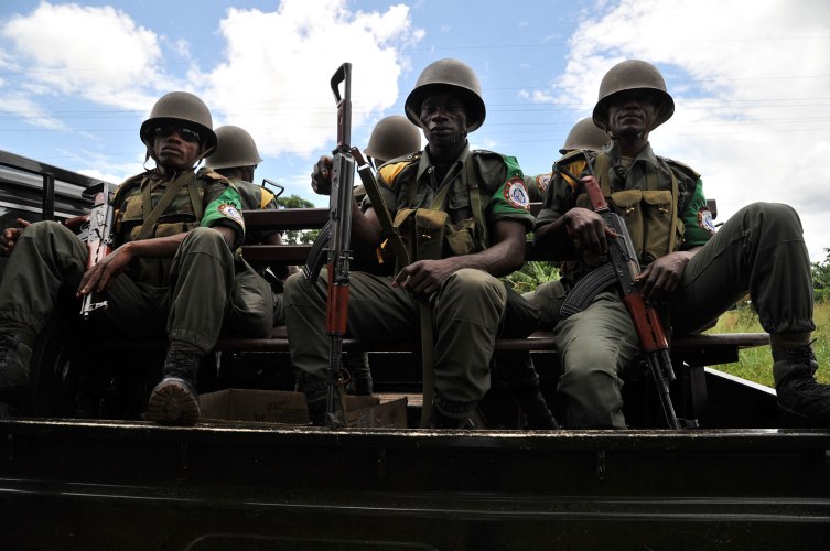 Soldiers from the Central African Multinational Force (FOMAC) sit in a vehicle as they patrol a road in a village near Bangui on October 6, 2013 during an operation to secure the disarmament of former Seleka rebels.
