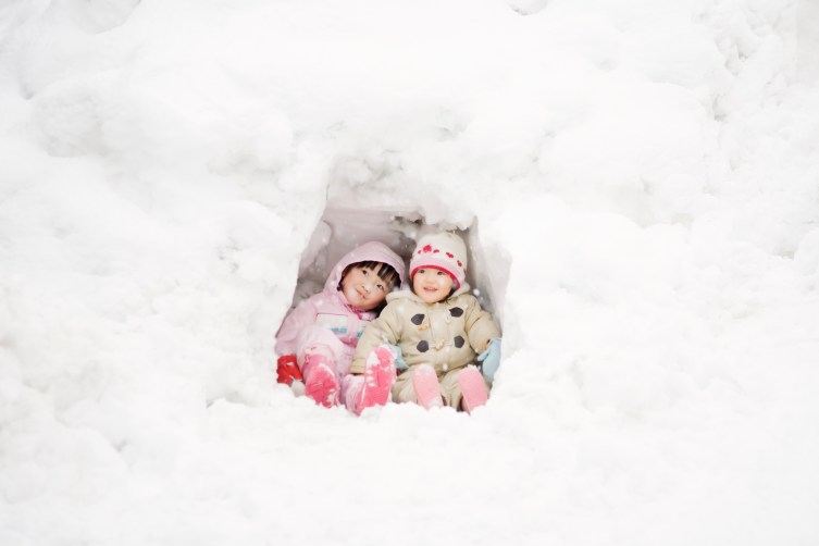 sisters playing with snow