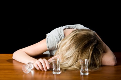A Young Woman Passed Out Drunk on a Bar Counter