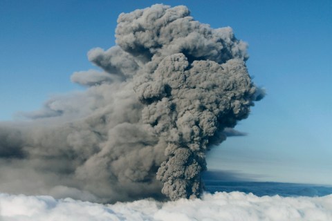 An ash plume rises from a volcano under the Eyjafjallajokull glacier