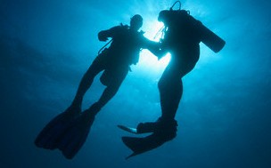 Two male divers in sea off Zanzibar