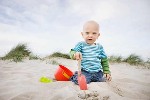 Baby boy playing on beach