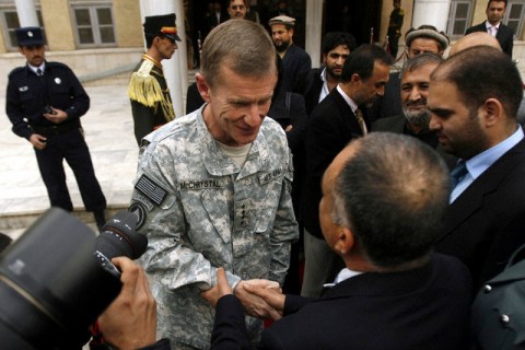 General Stanley McChrystal shakes hands with Afghan parliament members in Kabul