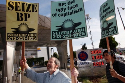 Protesters rally at the BP Green Curve ARCO gas station in Los Angeles during a national day of action against BP
