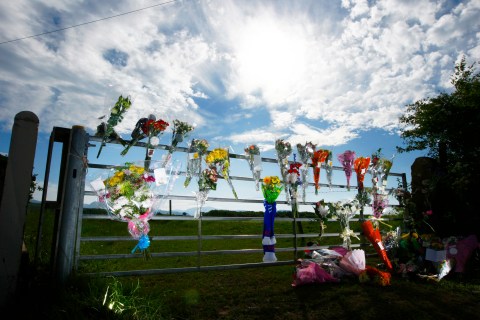 Floral tributes for Garry Purdham who was shot dead by Derrick Bird are seen at a gate near Gosforth in Cumbria