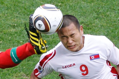 North Korea's Jong Tae-se heads the ball as Portugal's Ricardo Carvalho attempts to block him at Green Point stadium