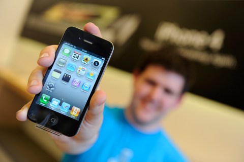 Ben Paton from Somerset, the first person to buy the new Apple iPhone 4 in Britain, poses with his phone inside the Apple store in central London