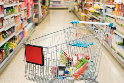 Shopping Cart in Supermarket Aisle