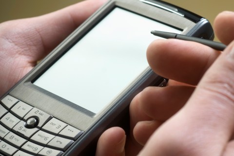 Detail of a Woman Using a Mobile Phone with a Digitized Pen