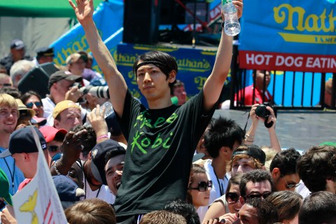 Takeru Kobayashi of Japan acknowledges the crowd from a spectators area at Nathan's annual hot dog eating contest in the Coney Island section of New York