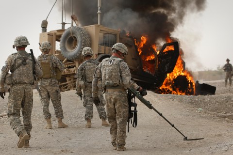 US Army EOD scans area around burning M-ATV armored vehicle after it struck an improvised explosive device near Combat Outpost Nolen in the Arghandab Valley