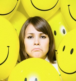 Woman with smiley face balloons