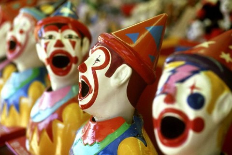 Row of Clown Heads for Side-show Alley Game at Funfair