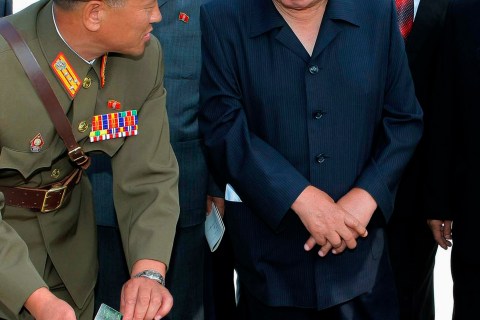 North Korean leader Kim Jong-il  looks at a book upon his visit to a construction site of the Kumyagang Army-People Power Station in North Korea in this picture released by North Korea's KCNA news agency