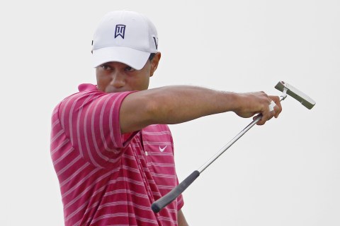 Woods wipes his face with his sleeve on the 12th green during practice round for the 92nd PGA Golf Championship in Haven