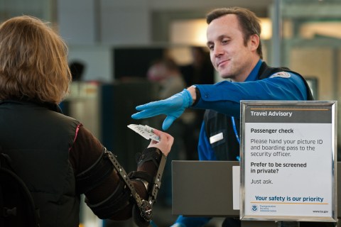 An airline passenger has her boarding pass