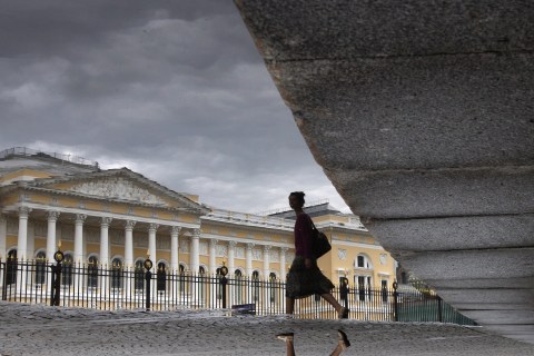 A woman walks in front of the Russian Museum in St. Petersburg