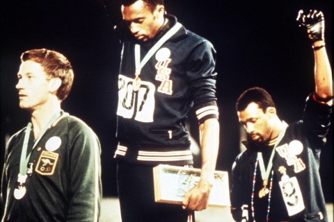 1968 Olympic Games Mexico City, Mexico. Men's 200 Metres Final. USA gold medallist Tommie Smith (C) and bronze medallist John Carlos give the black power salutes as an anti-racial protest as they stand on the podium with Australian silver medallist Peter