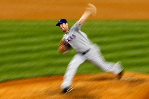 Texas Rangers starting pitcher Cliff Lee pitches to the New York Yankees in the first inning during Game 3 of their Major League Baseball ALCS playoff series in New York