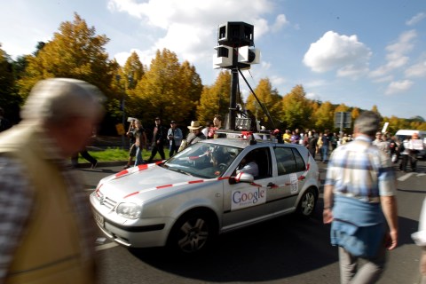 Demonstrators drive a car decorated to represent the Google Car used to create street view maps during a demonstration for data privacy in Berlin