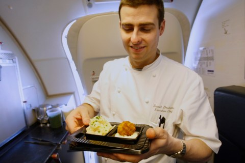 Executive Chef David Deshaies prepares Onion Carbonara by renowned chef Michel Richard aboard one of Openskies Airlines Boeing 757-200 jets that features business class only cabins at Washington Dulles International Airport