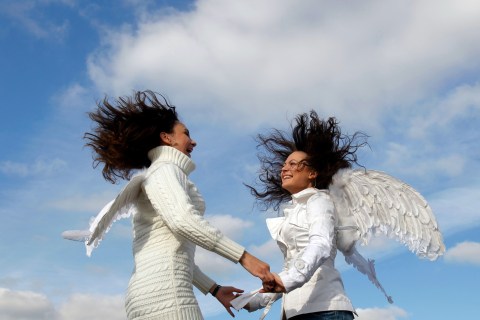 Cirque du Soleil fans, wearing angel wings, dance during a promotional event in Moscow