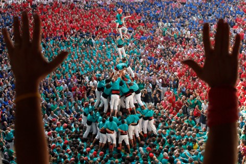 The group 'Castellers de Vilafranca' falls after forming a human tower called 'Castell' during a biannual competition in Tarragona city