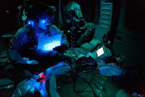 U.S. flight medic treats an unconscious fellow U.S. serviceman during a night time emergency airlift in southern Afghanistan