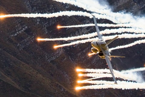 An aircraft of the Swiss Air Force releases flares during a flight demonstration of the Swiss Air Force over Axalp in the Bernese Oberland