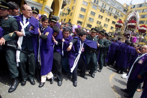 Believers dressed in purple congregate to pay homage to the "Lord of the Miracles" in Lima