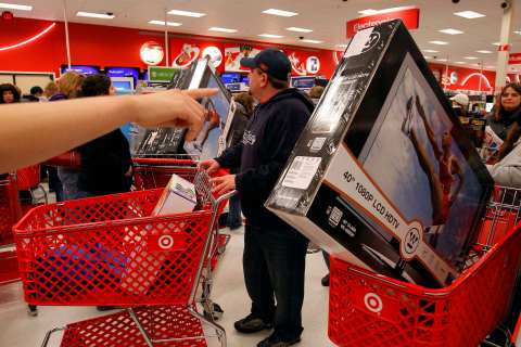 A Target store employee directs shoppers on Black Friday 
