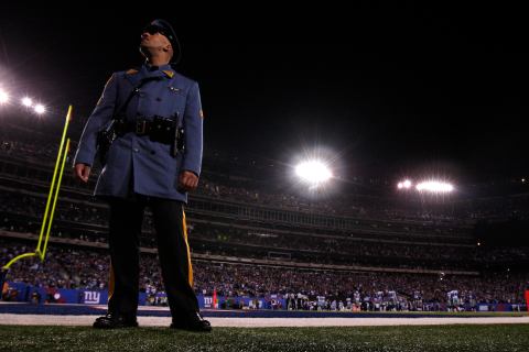 New Jersey State Police officer stands next to field during the power failure 