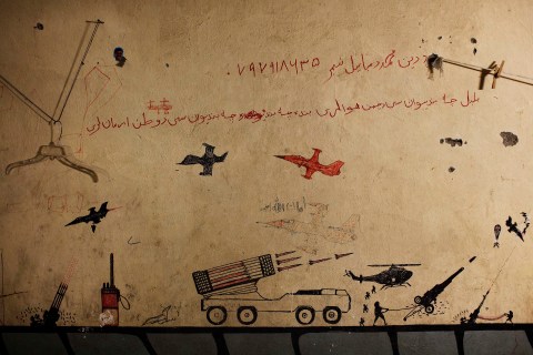 Graffiti left behind by Taliban fighters remains on the walls of a compound in southern Afghanistan's Helmand province