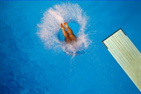 A competitor dives during practice before the women's synchronised 3m springboard diving final at the 16th Asian Games in Guangzhou
