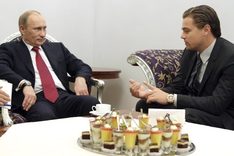 Russia's Prime Minister Putin listens to actor DiCaprio during their meeting, dedicated to International Tiger Forum, in St. Petersburg