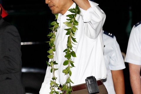U.S. President Barack Obama waves upon his arrival for a vacation in Hawaii