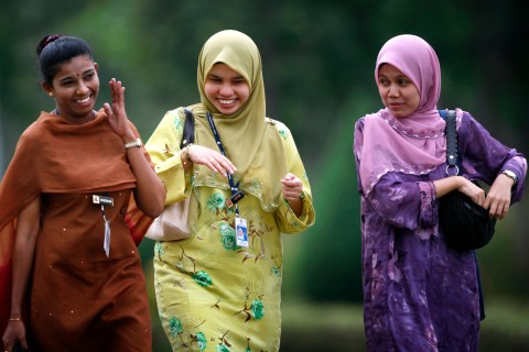 File photo of Malay and Indian women sharing a light moment as they leave office after work in Putrajaya outside Kuala Lumpur