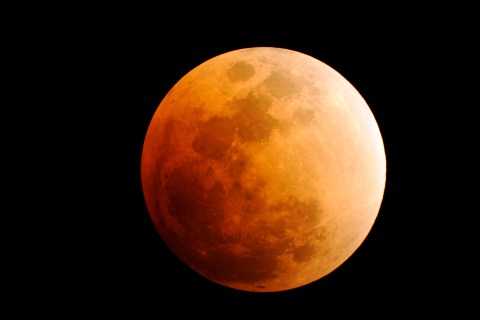 The moon is seen, during a phase of a total lunar eclipse, from a viewpoint in Palm Beach Gardens, Florida