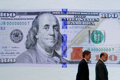 U.S. Treasury Secretary Geithner and Federal Reserve Chairman Bernanke leave a ceremony to debut the new design for the US$100 note at the Department of the Treasury in Washington