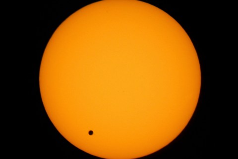Venus transits across the sun as seen over Hong Kong June 8, 2004. The transit of Venus, when the pl..