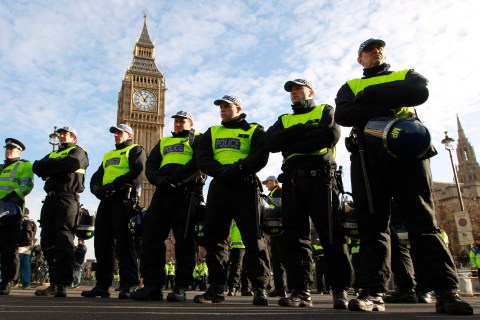 Police officers stand in Parliament Square, before a student protest, in central London