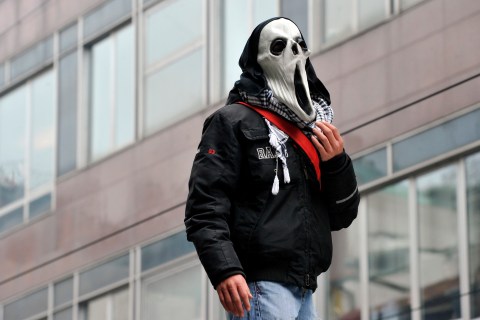 Demonstrator wears a mask during an anti-government  protest in Milan