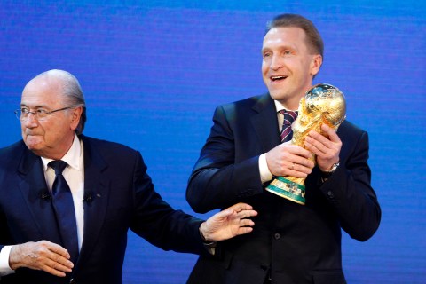 Russian Deputy Prime Minister Igor Shuvalov holds the World Cup trophy beside FIFA president Joseph Blatter