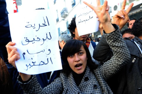 A Tunisian demonstrator flashes a victor