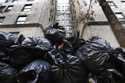 Garbage bags which broke the fall of a would-be suicide jumper are seen piled up outside 325 West 45th Street in New York