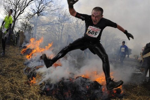 Competitor runs through a burning field during the Tough Guy event in Perton